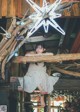 A woman sitting on top of a wooden structure.