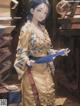 A woman in a kimono holding a blue book.